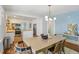 Bright dining room with contemporary lighting and an open view to a modern kitchen at 1633 Woodbine Ne Ave, Atlanta, GA 30317
