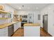 Modern kitchen with stainless steel appliances, butcher block countertops and an island at 1633 Woodbine Ne Ave, Atlanta, GA 30317