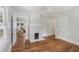 Inviting living room featuring a white-painted brick fireplace and access to other rooms at 1633 Woodbine Ne Ave, Atlanta, GA 30317