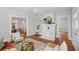 Cozy living room with a white brick fireplace, hardwood floors, and views of the dining area at 1633 Woodbine Ne Ave, Atlanta, GA 30317
