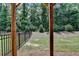 A green and fenced backyard with mature trees viewed through a wooden pergola at 2719 Hedgeway Cir, Kennesaw, GA 30144