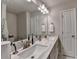 Modern bathroom featuring dual sinks, a large mirror, and contemporary lighting fixtures at 2719 Hedgeway Cir, Kennesaw, GA 30144