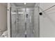 Modern bathroom features a glass-enclosed shower with gray tiled walls, offering a sleek and contemporary look at 2719 Hedgeway Cir, Kennesaw, GA 30144