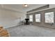 Spacious bedroom with neutral carpet, three large windows offering natural light, and a comfortable seating area at 2719 Hedgeway Cir, Kennesaw, GA 30144