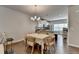 Stylish dining area featuring wood floors, pendant lighting, and a modern kitchen in the background at 2719 Hedgeway Cir, Kennesaw, GA 30144