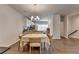 Bright dining area features hardwood floors, modern chandelier, and adjacent kitchen at 2719 Hedgeway Cir, Kennesaw, GA 30144