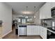Stylish kitchen with stainless steel appliances and granite counters seamlessly blending into the living space at 2719 Hedgeway Cir, Kennesaw, GA 30144