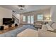 Open-concept living area with hardwood floors, modern lighting, and comfortable seating arrangements at 2719 Hedgeway Cir, Kennesaw, GA 30144