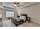 Comfortable main bedroom with tray ceiling, ceiling fan and lots of natural light at 2719 Hedgeway Cir, Kennesaw, GA 30144