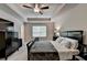 Spacious main bedroom featuring a tray ceiling, ceiling fan, and a serene atmosphere at 2719 Hedgeway Cir, Kennesaw, GA 30144