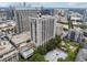 A lovely aerial view of the building and surrounding neighborhood, including a refreshing outdoor pool at 3040 Peachtree Rd, Atlanta, GA 30305