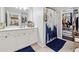 Well-lit bathroom with double sinks, a spacious walk-in closet, and modern fixtures at 3040 Peachtree Rd, Atlanta, GA 30305