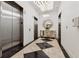Elegant elevator lobby featuring stylish tile flooring, modern lighting, and a decorative mirror at 3040 Peachtree Rd, Atlanta, GA 30305