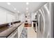 Spacious kitchen with stainless steel appliances, granite countertops and view to the living space at 3040 Peachtree Rd, Atlanta, GA 30305