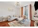 Bright living room featuring hardwood floors, a modern light fixture, and large windows with city views at 3040 Peachtree Rd, Atlanta, GA 30305