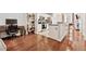 Open concept living space featuring hardwood floors, breakfast bar, and an adjacent work space at 3040 Peachtree Rd, Atlanta, GA 30305