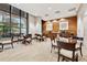 Inviting lounge area with glass tables, comfortable chairs, large windows and a kitchenette for relaxed gatherings at 3040 Peachtree Rd, Atlanta, GA 30305