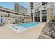 Outdoor pool and lounge chairs with partial building views, featuring a soothing blue water and relaxing setting at 3040 Peachtree Rd, Atlanta, GA 30305