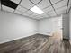 Finished basement with drop ceiling and wood-look flooring at 643 Windy Mill Way, Temple, GA 30179