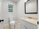 Neat bathroom with single vanity, toilet and decorative mirror at 643 Windy Mill Way, Temple, GA 30179