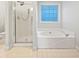 Bright bathroom featuring a tub, shower and tile flooring at 643 Windy Mill Way, Temple, GA 30179