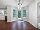 Bright dining room with hardwood floors, modern lighting, and access to the deck at 643 Windy Mill Way, Temple, GA 30179