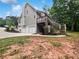 Home featuring a three-car garage, a wooden deck, with lots of green landscaping at 643 Windy Mill Way, Temple, GA 30179
