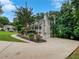 Home featuring a three-car garage, manicured landscaping, and a long driveway at 643 Windy Mill Way, Temple, GA 30179
