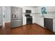 Modern kitchen features stainless steel appliances, white cabinets, and granite countertops at 643 Windy Mill Way, Temple, GA 30179