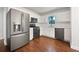 Well-lit kitchen featuring stainless steel appliances, white cabinets, and a window at 643 Windy Mill Way, Temple, GA 30179