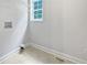 A utility room with tile flooring, a window, and a shelf at 643 Windy Mill Way, Temple, GA 30179