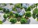 Beautiful home with mature landscaping; aerial perspective highlighting the lush surroundings and elegant architectural details at 6930 Wesley Hughes Rd, Cumming, GA 30040