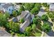High-angle aerial view of a home featuring mature trees and lush landscaping with a winding driveway at 6930 Wesley Hughes Rd, Cumming, GA 30040