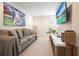 Cozy basement area features a large sofa, modern entertainment system, and decorative accents at 6930 Wesley Hughes Rd, Cumming, GA 30040