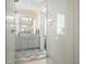 Bathroom featuring glass shower and elegant gray and white color palette at 6930 Wesley Hughes Rd, Cumming, GA 30040