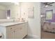 Bright bathroom features marble countertops, vanity with ample storage, and access to the bedroom at 6930 Wesley Hughes Rd, Cumming, GA 30040