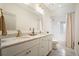 Clean bathroom featuring a marble countertop, double sinks, and a shower and tub combo at 6930 Wesley Hughes Rd, Cumming, GA 30040