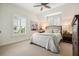 Inviting bedroom featuring shuttered windows, a cow painting and neutral color palette at 6930 Wesley Hughes Rd, Cumming, GA 30040