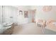 Bright bedroom featuring a pink themed area, comfy chair, and white closet doors at 6930 Wesley Hughes Rd, Cumming, GA 30040