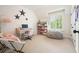 Bright bedroom features a desk, beanbag, and ample natural light from the window at 6930 Wesley Hughes Rd, Cumming, GA 30040