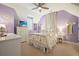 Charming bedroom featuring a decorative dream catcher, television, and complementary pastel color scheme at 6930 Wesley Hughes Rd, Cumming, GA 30040