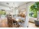 Spacious dining area with a large table and abundant natural light, ideal for Gathering meals and gatherings at 6930 Wesley Hughes Rd, Cumming, GA 30040