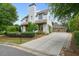 Charming home with a manicured front yard, long driveway, and detached garage providing ample parking at 6930 Wesley Hughes Rd, Cumming, GA 30040