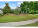 Well-manicured front yard featuring a lush lawn, mature trees, and tasteful landscaping enhances curb appeal at 6930 Wesley Hughes Rd, Cumming, GA 30040