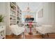 Bright home office with built-in bookshelves, modern chandelier, and comfortable seating at 6930 Wesley Hughes Rd, Cumming, GA 30040