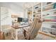 Well-lit home office with built-in shelves, a large desk, and comfortable seating at 6930 Wesley Hughes Rd, Cumming, GA 30040