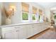 Kitchen showcasing bright, underlit countertops and white cabinets with bronze handles at 6930 Wesley Hughes Rd, Cumming, GA 30040