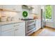 Well-equipped kitchen features stainless steel appliances, granite countertops, and stylish white cabinetry at 6930 Wesley Hughes Rd, Cumming, GA 30040