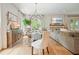 Combined living and dining spaces provide ample space for entertaining, filled with natural light at 6930 Wesley Hughes Rd, Cumming, GA 30040