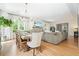 Bright, open-concept living and dining areas with a fireplace and large windows create an inviting atmosphere at 6930 Wesley Hughes Rd, Cumming, GA 30040